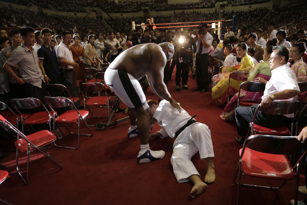 North Koreans watch as Bob "The Beast" Sapp, center left, struggles with his opponent during a pro wrestling exhibition, Sunday, Aug. 31, 2014 in Pyongyang, North Korea. (AP Photo/Kim Kwang  ...
