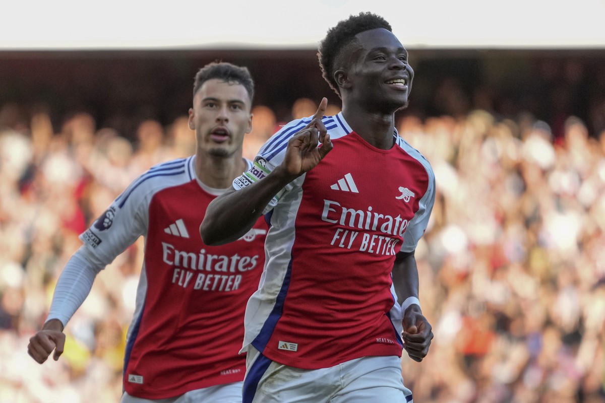 Arsenal's Bukayo Saka, right, celebrates after scoring his side's third goal during the English Premier League soccer match between Arsenal and Southampton at the Emirates Stadium in London, ...