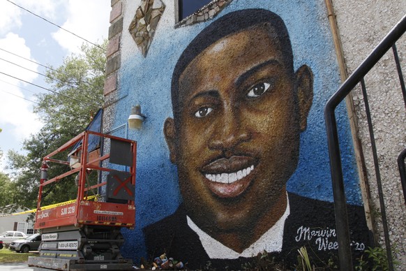 FILE - A painted mural of Ahmaud Arbery is displayed on May 17, 2020, in Brunswick, Ga., where the 25-year-old man was shot and killed in February. (AP Photo/Sarah Blake Morgan, file)