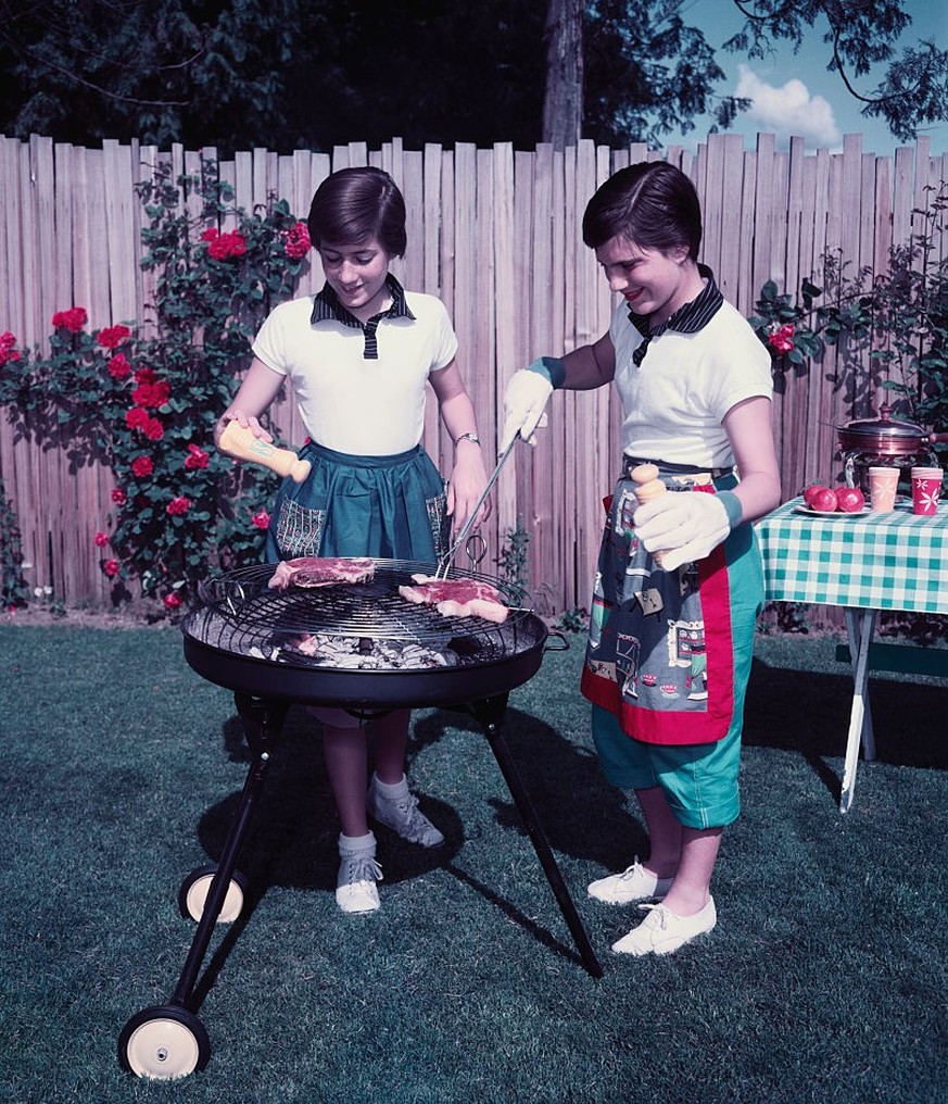 Sisters Barbecuing in Backyard (Photo by �� Josef Scaylea/CORBIS/Corbis via Getty Images)