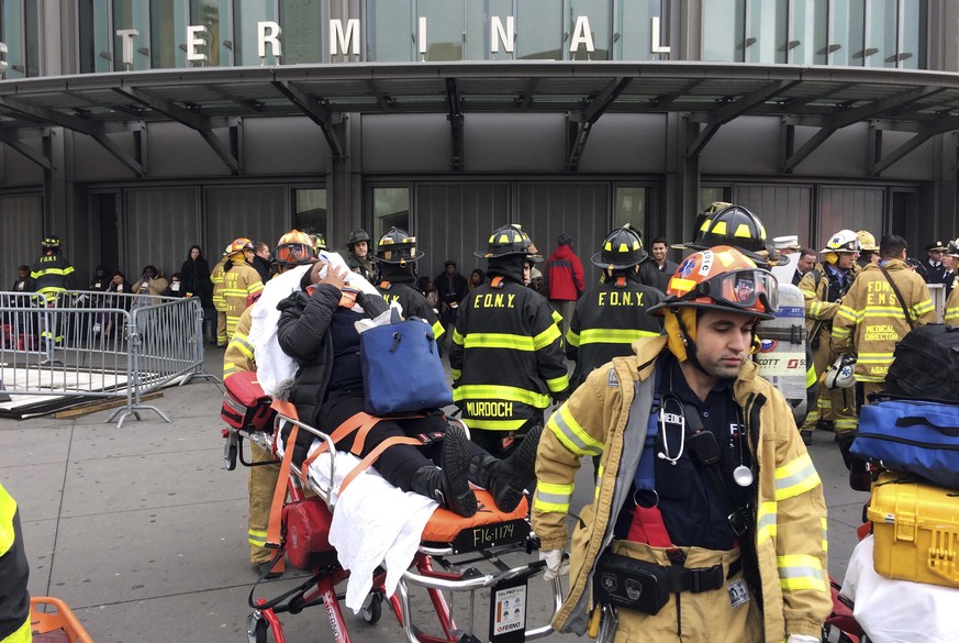An injured passenger, after a Long Island Rail Road commuter train either hit something or derailed, is taken from the Atlantic Terminal, in the Brooklyn borough of New York, Wednesday, Jan. 4, 2017.  ...