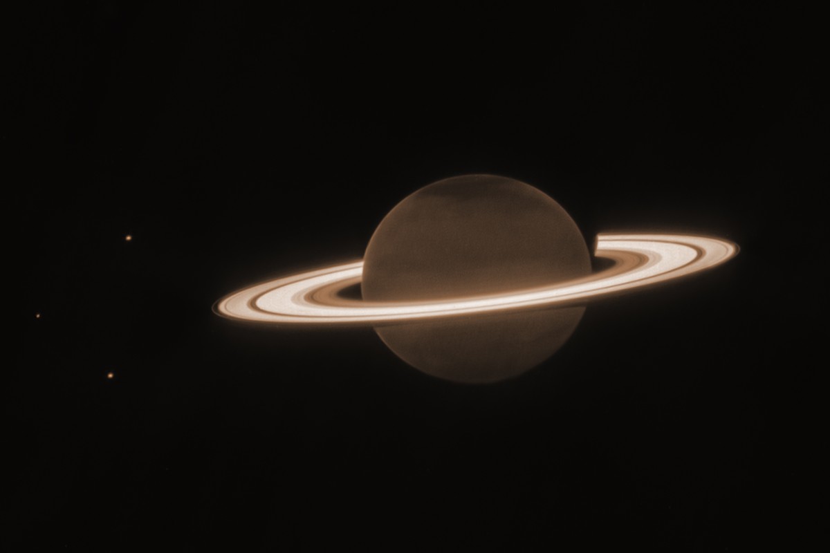 This June 2023 image provided by the Space Telescope Science Institute shows the planet Saturn and three of its moons, from left, Enceladus, Tethys and Dione, captured by the James Webb Space Telescop ...