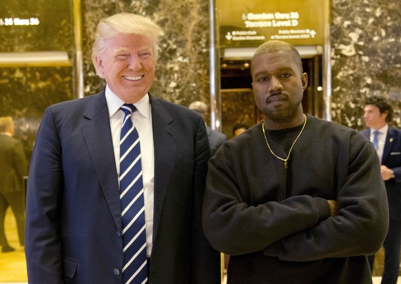 FILE - In this Dec. 13, 2016, file photo, President-elect Donald Trump and Kanye West pose for a picture in the lobby of Trump Tower in New York. Kanye West will visit the White House on Thursday to m ...