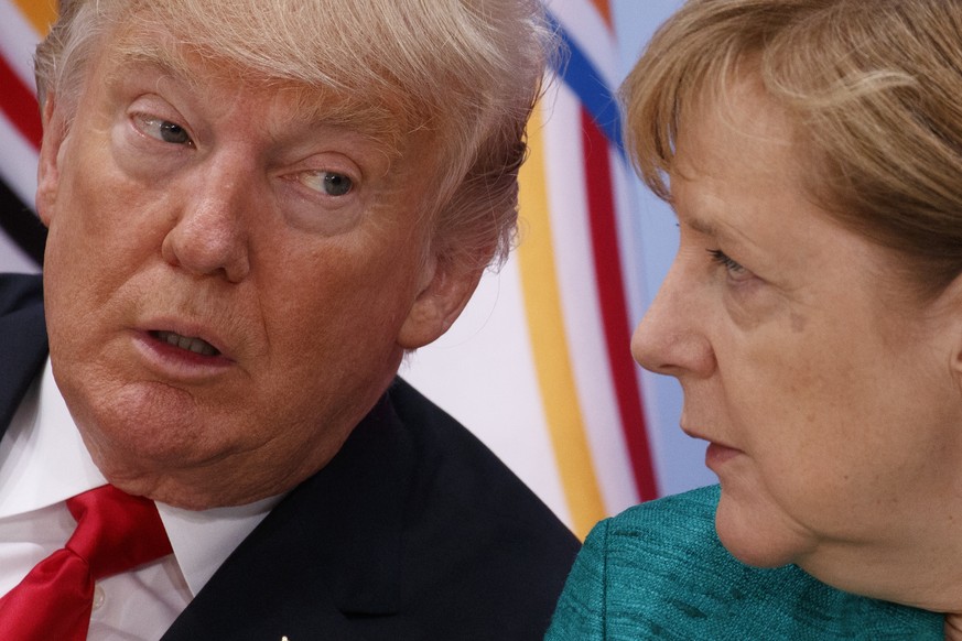 President Donald Trump, left, talks with German Chancellor Angela Merkel during the Women&#039;s Entrepreneurship Finance event at the G20 Summit, Saturday, July 8, 2017, in Hamburg. (AP Photo/Evan Vu ...