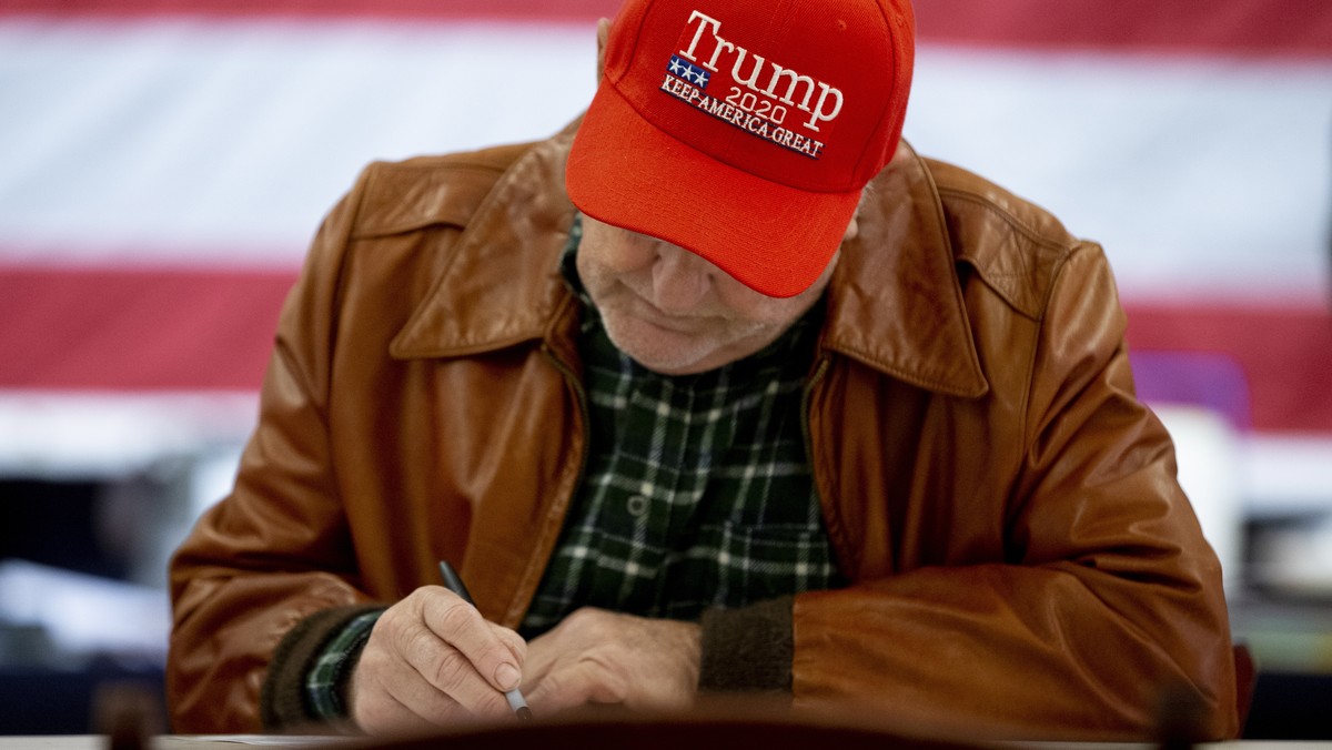 epa10293645 A Trump supporter votes with a write-in ballot on election day at a polling location at the Old Stone School in Hillsboro, Virginia, USA, 08 November 2022. The US midterm elections are hel ...