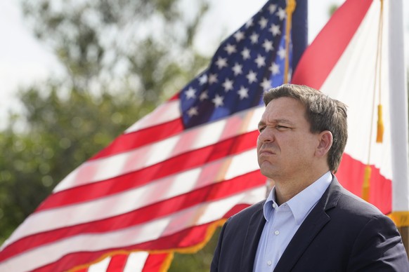 Florida Gov. Ron DeSantis listens during a news conference, Tuesday, Aug. 3, 2021, near the Shark Valley Visitor Center in Miami. DeSantis is doubling down as the state again broke its record for COVI ...