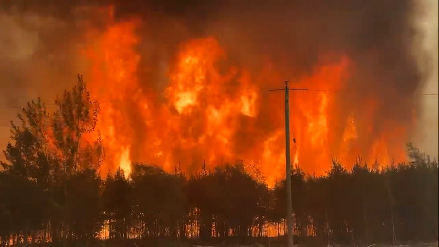 epa12145314 A handout photo made available by the Government of Manitoba shows a large wildfire spreading northwest of the town of The Pas in Manitoba, Canada, 29 May 2025 (issued 30 May 2025). The wi ...