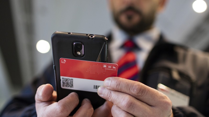 ZUR EINFUEHRUNG DES SWISSPASSES VOR DREI MONATEN STELLEN WIR IHNEN HEUTE, MITTWOCH, 4. NOVEMBER 2015, FOLGENDES NEUES BILDMATERIAL ZUR VERFUEGUNG --- Conductor Salvatore Grade verifies a train passeng ...