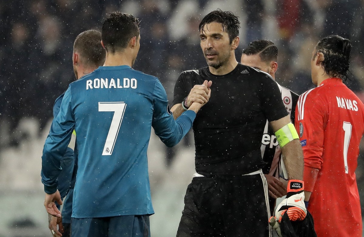 Juventus goalkeeper Gianluigi Buffon, right, shakes hands with Real Madrid's Cristiano Ronaldo after the Champions League, round of 8, first-leg soccer match between Juventus and Real Madrid at t ...