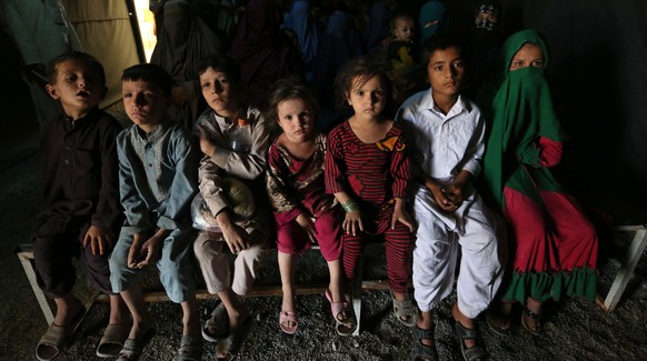 Returning Afghans, who have recently arrived from Pakistan, wait during the registration process at the United Nations High Commissioner for Refugees (UNHCR) registration center on the outskirts of Ka ...