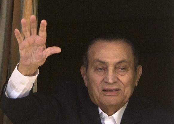 FILE - In this April 25, 2016 file photo, ousted Egyptian President Hosni Mubarak waves to his supporters from his room at the Maadi Military Hospital, where he is hospitalized, in Cairo, Egypt. Egypt ...