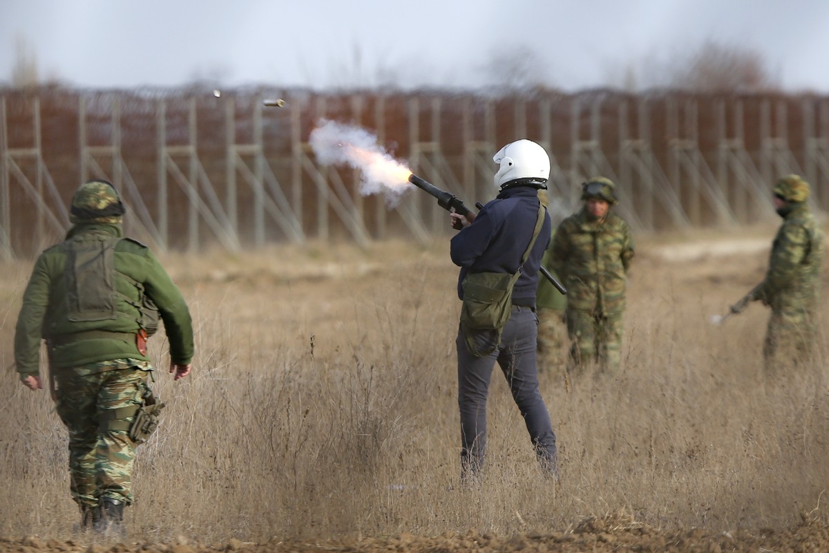 Greek military fire teargas canisters during clashes between migrants and Greek police and army personnel near the Kastanies border gate at the Greek-Turkish border, Sunday, March 1, 2020. Migrants an ...