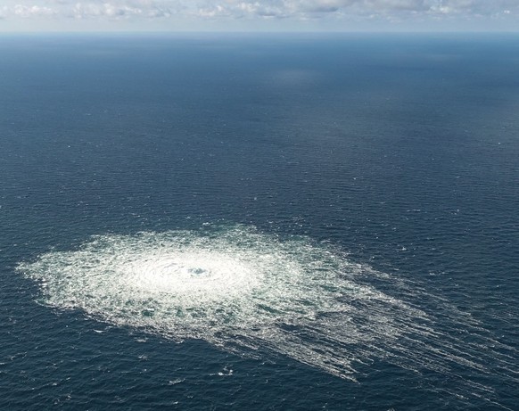 epa10209592 A handout photo taken from a Danish F-16 jet on 27 September 2022 and made available by the Danish Defence Command shows a gas leak of the Nord Stream 2 pipeline off Bornholm, Denmark, Bal ...