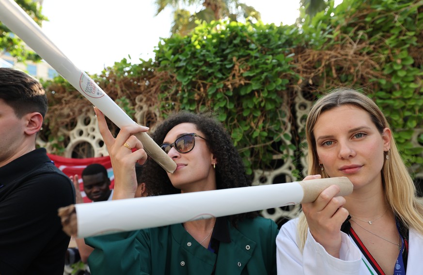 epa11010451 Activists hold oversized mock cigarettes under the motto &#039;You would not see tobacco at a Health conference&#039; as they protest and call for making the &#039;big polluters pay&#039;  ...