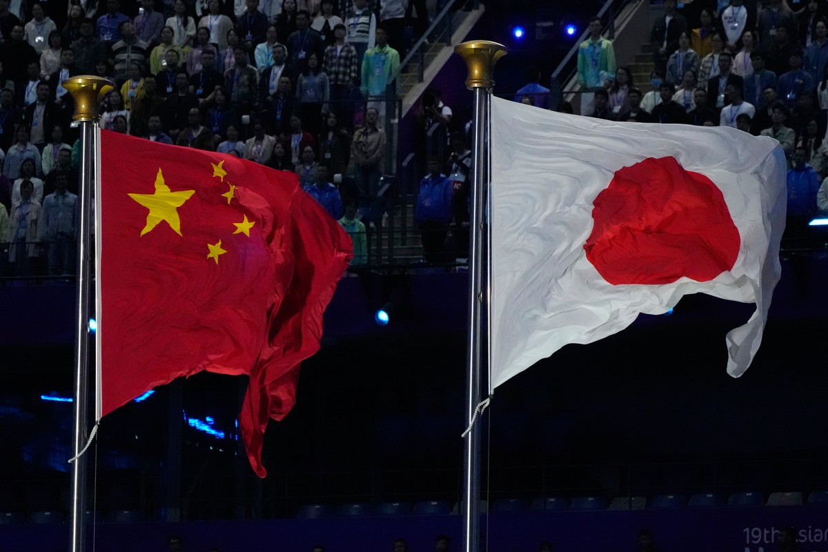 FILE - The flags of China and Japan are flown at the during the handover ceremony from China to Japan the next host of the Asian Games at the closing ceremony of the 19th Asian Games in Hangzhou, Chin ...