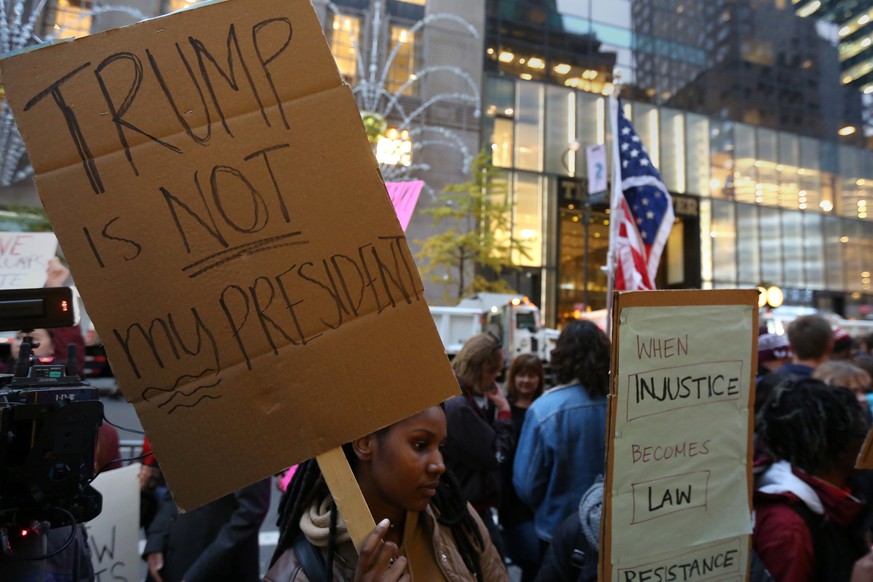 Protesters demonstrate across the street from Trump Tower after the election selected Republican president-elect Donald Trump in New York, New York, U.S. November 9, 2016. REUTERS/Carlo Allegri