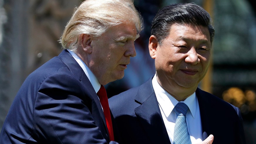 FILE - In this April 7, 2017, file photo, U.S. President Donald Trump gestures as he and Chinese President Xi Jinping walk after their meetings at Mar-a-Lago in Palm Beach, Fla. A year after Trump tri ...