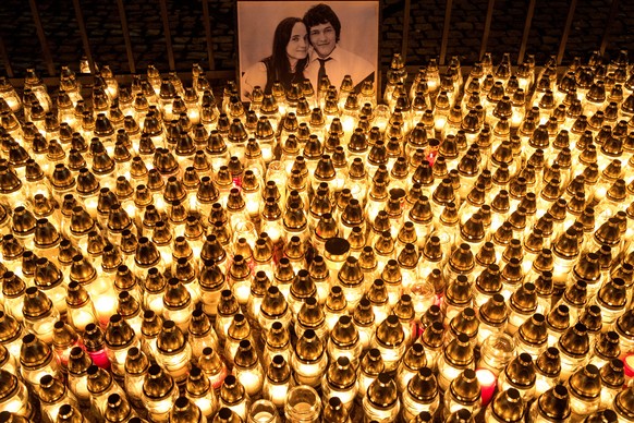 epa06571097 Candles are placed during a march in memory of murdered Slovak journalist Jan Kuciak in front of the Slovak government building in Bratislava, Slovakia, 28 February 2018. Kuciak was found  ...