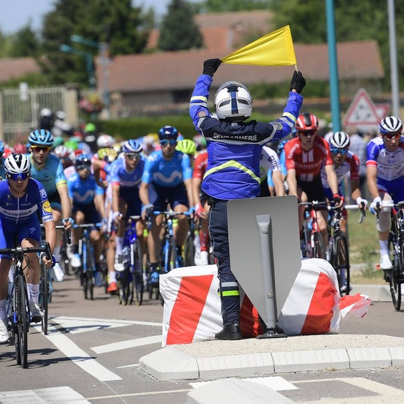 Tour de France 2019 - Stage 04 NANCY, FRANCE - JULY 9 : The peloton passing a policeman with a yellow security flag during stage 4 of the 106th edition of the 2019 Tour de France cycling race, a stage ...