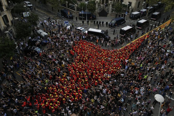 Firefighters join protesters outside the Spanish government delegation during a one-day strike in Barcelona, Spain, Tue sday Oct. 3, 2017. Labor unions and grassroots pro-independence groups are urgin ...