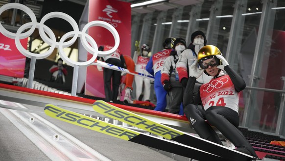 Simon Ammann, of Switzerland, adjusts his goggles during the men&#039;s normal hill individual ski jumping trial round at the 2022 Winter Olympics, Sunday, Feb. 6, 2022, in Zhangjiakou, China. (AP Pho ...