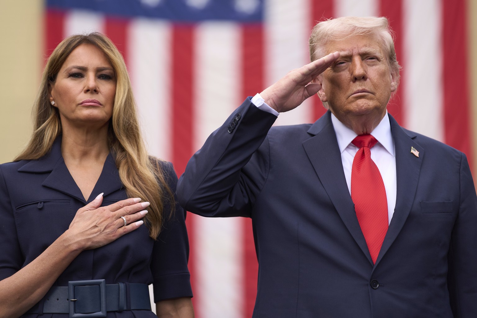 President Donald Trump and first lady Melania Trump stand as Taps is played during a ceremony to commemorate the 24th anniversary of the 9/11 attacks, Thursday, Sept. 11, 2025, at the Pentagon in Wash ...