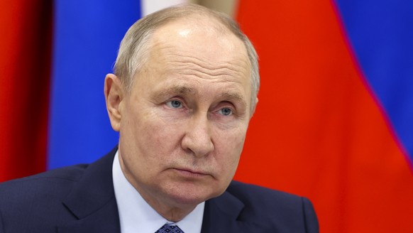 FILE - Russian President Vladimir Putin attends a meeting with officials in the city of Tsivilsk, Republic of Chuvash, Russia, February 22, 2024. The US government hits Russia with the greatest tra...
