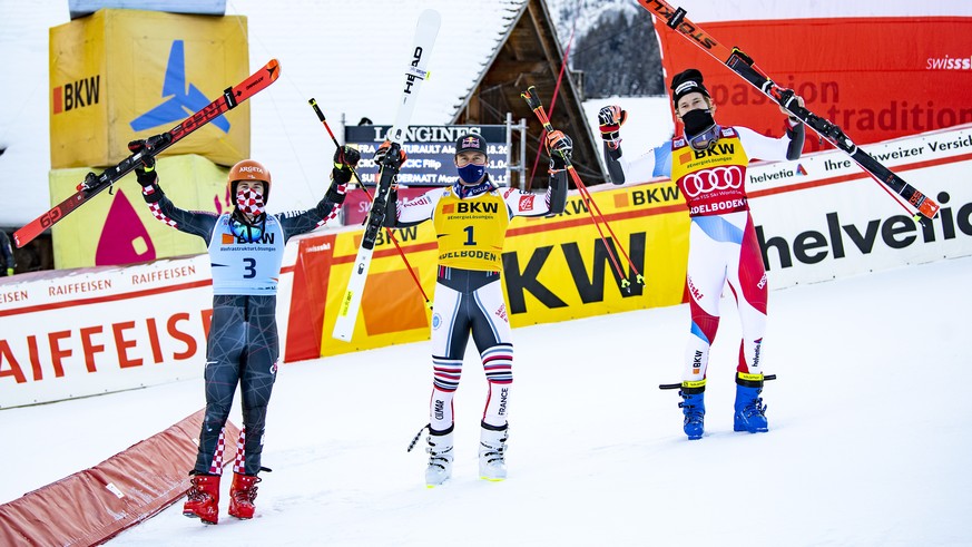 Third placed Marco Odermatt of Switzerland, right, second placed Filip Zubcic of Croatia, left, and winner Alexis Pinturault of France, center, celebrate in the finish area after the second run of the ...