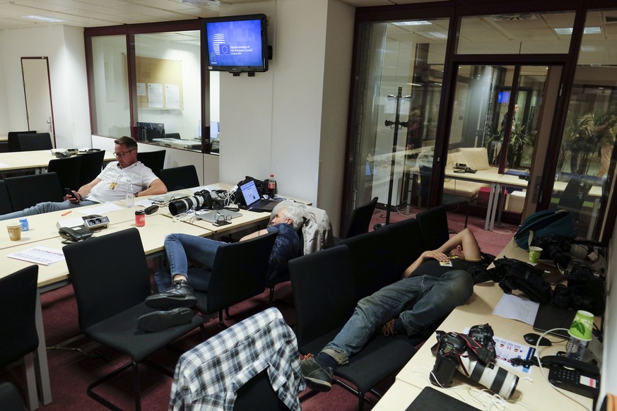 epa07686340 Journalists take a break during a long night of negotiation at a Special European Council in Brussels, Belgium, 01 July 2019. Heads of states or governments from EU member states meet to c ...