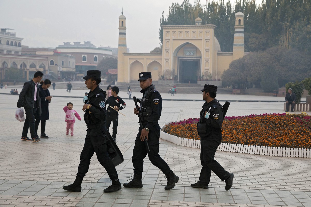 FILE - In this Nov. 4, 2017, file photo, Uighur security personnel patrol near the Id Kah Mosque in Kashgar in western China's Xinjiang region. China says on Monday, March 18, 2019 it has arreste ...