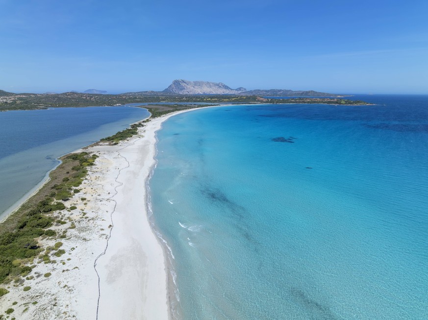 Aerial view of the idyllic Spiaggia La Cinta in Sardinia, Italy with turquoise waters and a sandy coastline., RUEF04676