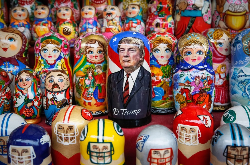 epa05625566 A matryoshka doll with the face of US President-elect Donald Trump surrounded by other matryoshkas is displayed on the table of the street souvenir vendor in the Andriyivskyy Descent in do ...