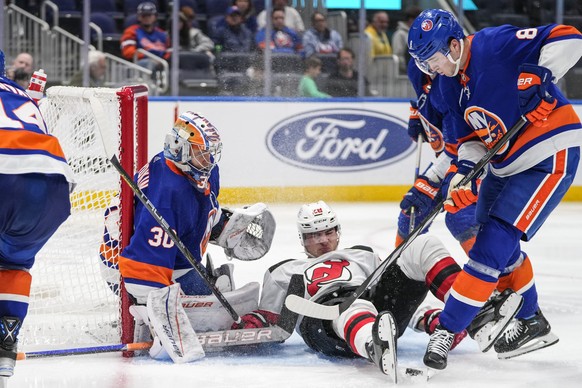 New York Islanders&#039; Noah Dobson (8) and goaltender Ilya Sorokin (30) protect the net from New Jersey Devils&#039; Timo Meier (28) during the third period of an NHL hockey game Friday, Oct. 20, 20 ...