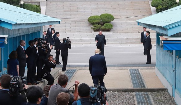 In this Sunday, June 30, 2019, photo provided by the North Korean government, North Korean leader Kim Jong Un, rear center, meets U.S. President Donald Trump, center, at the border village of Panmunjo ...