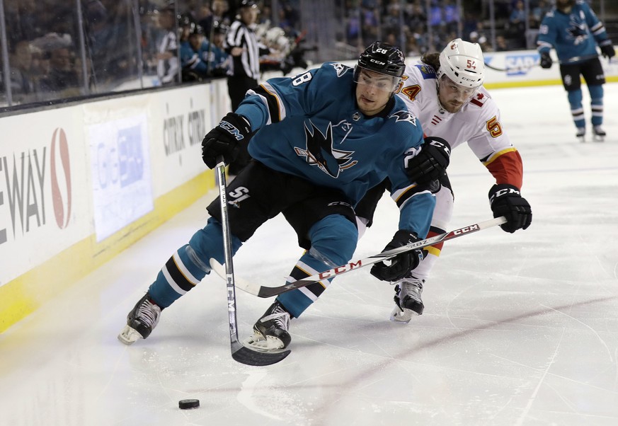 San Jose Sharks&#039; Timo Meier, left, is defended by Calgary Flames&#039; Rasmus Andersson during the second period of an NHL hockey game Saturday, March 24, 2018, in San Jose, Calif. (AP Photo/Marc ...