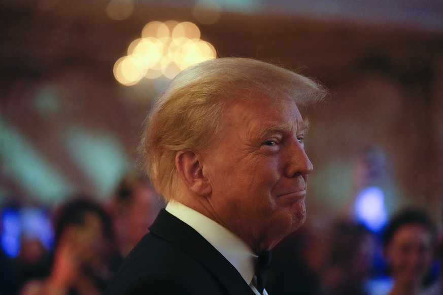 Former President Donald Trump smiles toward guests, as he arrives to speak at an event at Mar-a-Lago, Friday, Nov. 18, 2022, in Palm Beach, Fla. Earlier in the day Attorney General Merrick Garland nam ...