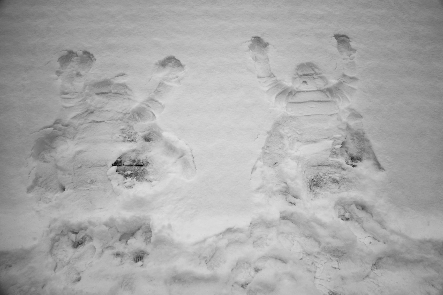 Impressions of persons are seen in the snow at the roof of sliding center during the 2022 Winter Olympics, Sunday, Feb. 13, 2022, in the Yanqing district of Beijing. (AP Photo/Pavel Golovkin)