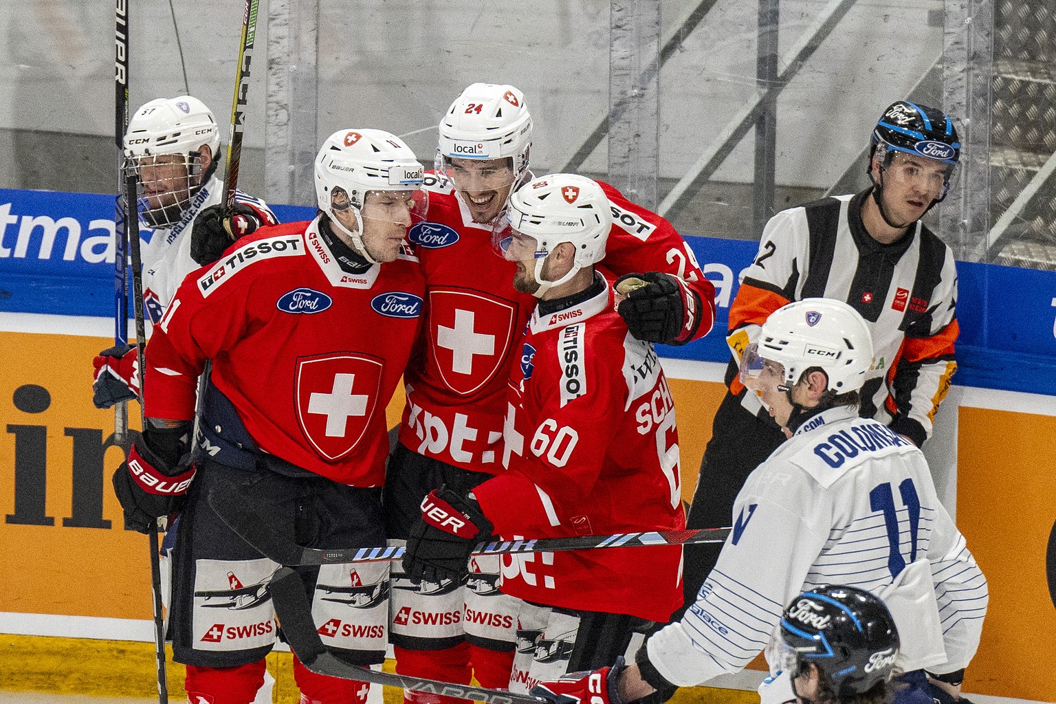 Switzerland&#039;s Sven Senteler, Tobias Geisser and Tristan Scherwey, from left, celebrate their scores to 3-2 during an ice hockey World Cup preparation match between Switzerland and France at the S ...