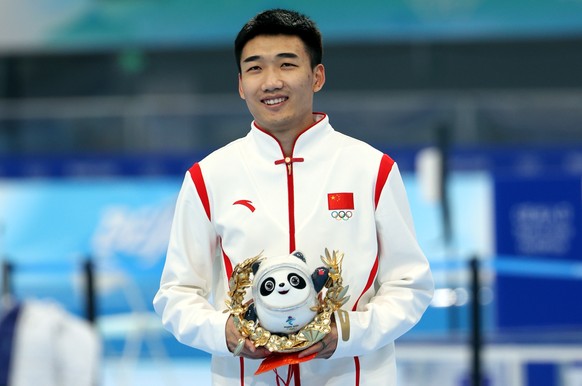 epa09749041 First placed Tingyu Gao of China celebrates during the award ceremony of the Men&#039;s Speed Skating 500m event at the Beijing 2022 Olympic Games, Beijing, China, 12 February 2022. EPA/JE ...