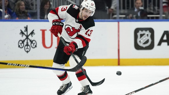 New Jersey Devils center Nico Hischier passes the puck during the third period of the team's NHL hockey game against the New York Islanders, Thursday, Oct. 20, 2022, in Elmont, N.Y. The Devils won 4-1 ...