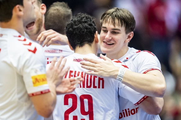 Switzerland&#039;s Felix Aellen, right, and Switzerland&#039;s Samuel Zehnder, center celebrate after the Men&#039;s Handball World Championships main round round match between Italia and Switzerland  ...