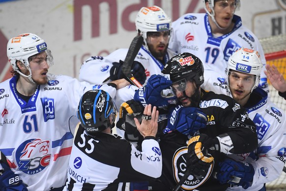 Zurich&#039;s player Fabrice Herzog, left, fights with Luganoâs player Julian Walker, during the seventh match of the playoff final of the National League of the ice hockey Swiss Championship betwee ...