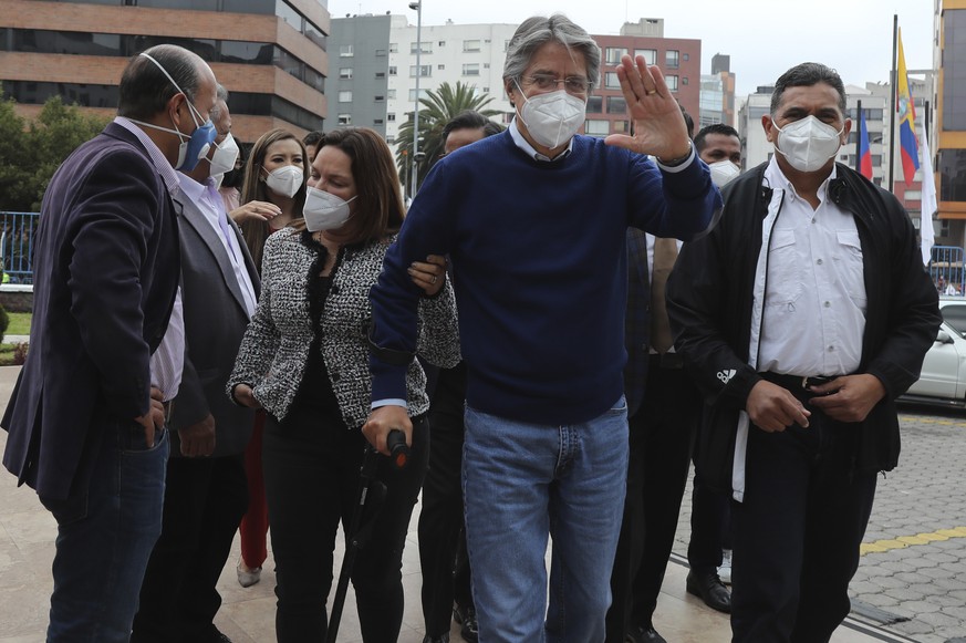 Presidential candidate Guillermo Lasso, representing the Creating Opportunities party or CREO, waves as he arrives to attend an event with rival Yaku Perez, of the Pachakutik political party, at the N ...