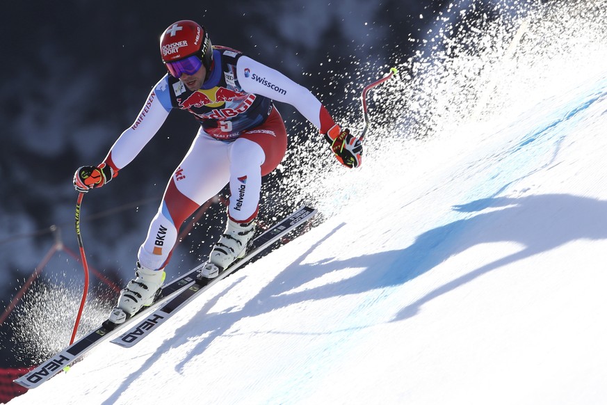 Switzerland&#039;s Beat Feuz speeds down the course during an alpine ski, men&#039;s World Cup downhill in Kitzb�1?4hel, Austria, Friday, Jan. 22, 2021. (AP Photo/Marco Trovati)