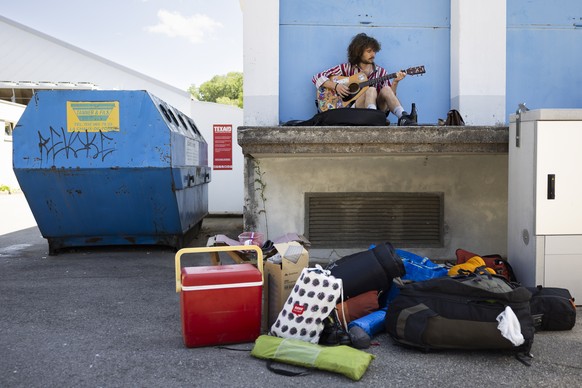 epa10755292 Participant Lilu of Germany plays guitar during the international anti-authoritarian gathering Anarchy 2023 in St-Imier, Switzerland, on 19 July 2023. The gathering takes place from July 1 ...