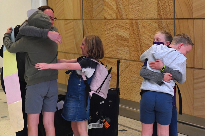 epa09144439 A family from New Zealand reunite at Sydney International Airport, Sydney, Australia, 19 April 2021. From Sunday night, travellers from Australia were once again able to travel to New Zeal ...