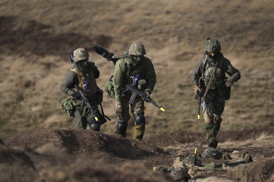 Ukrainian soldiers take part in a military exercise at a military training camp in Northern England, Thursday, Feb. 16, 2023, ahead of the anniversary of the invasion of Ukraine. (AP Photo/Scott Heppe ...