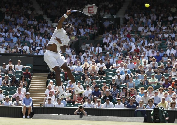 Gael Monfils of France serves the ball to Britain&#039;s Kyle Edmund during their Men&#039;s Singles Match on day four at the Wimbledon Tennis Championships in London Thursday, July 6, 2017. (AP Photo ...