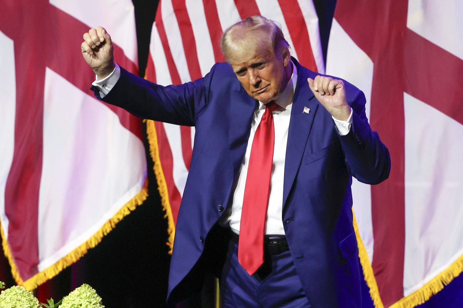 Former President Donald Trump dances as he leaves the stage after speaking at a fundraiser event for the Alabama GOP, Friday, Aug. 4, 2023, in Montgomery, Ala. (AP Photo/Butch Dill)