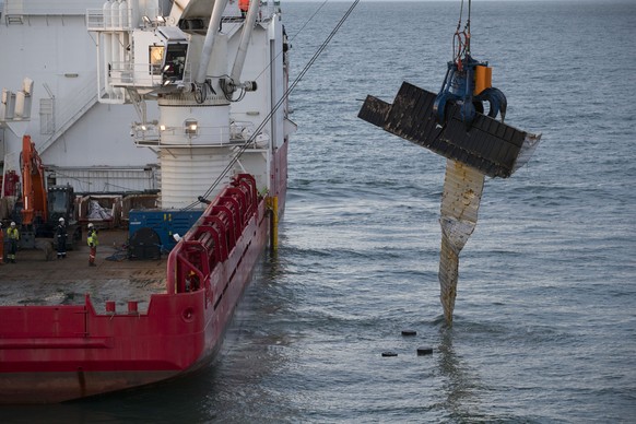 In this Monday, Jan. 21, 2019, file image, The Geosund salvaging ship lifts a container from the seabed off the northwestern coast of the Netherlands. Dutch authorities say a freight ship lost dozens  ...